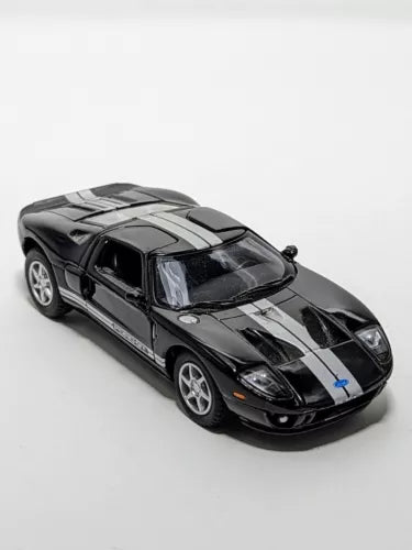 Kinsmart 2006 Ford GT diecast toy car, black with gray stripes, front 3/4 view.