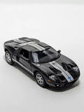 Kinsmart 2006 Ford GT diecast toy car, black with gray stripes, front 3/4 view.
