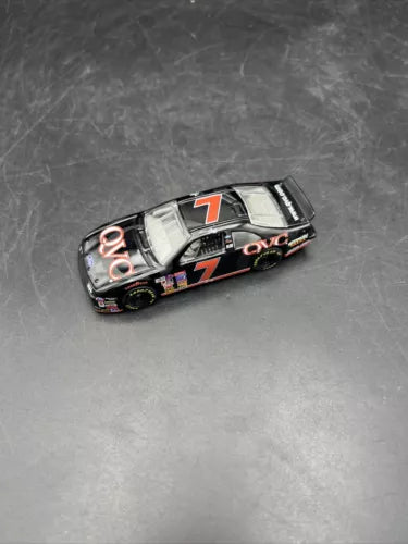 Black diecast race car with number 7 on hood and side, white racing stripes
