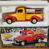 Yellow vintage diecast pickup truck with red wheels, detailed cab and open bed