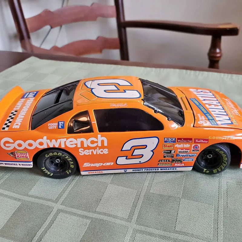 Orange and black NASCAR-style diecast race car piggy bank with #3 decal