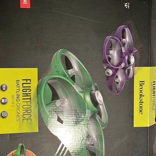 Two battle drones: green and purple quadcopters with visible propellers and body details.