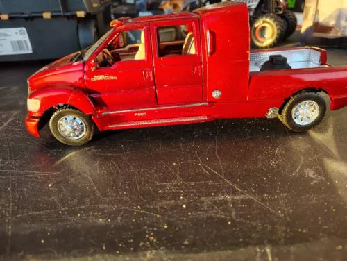 Red diecast Ford F-650 pickup truck with damaged front