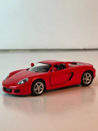 Red Porsche Carrera GT 1:36 diecast toy car, front three-quarter view