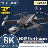 Foldable quadcopter drone with dual cameras, gray body and four spinning propellers