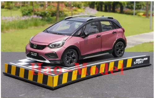 Pink diecast model hatchback car with black wheels and sporty body details