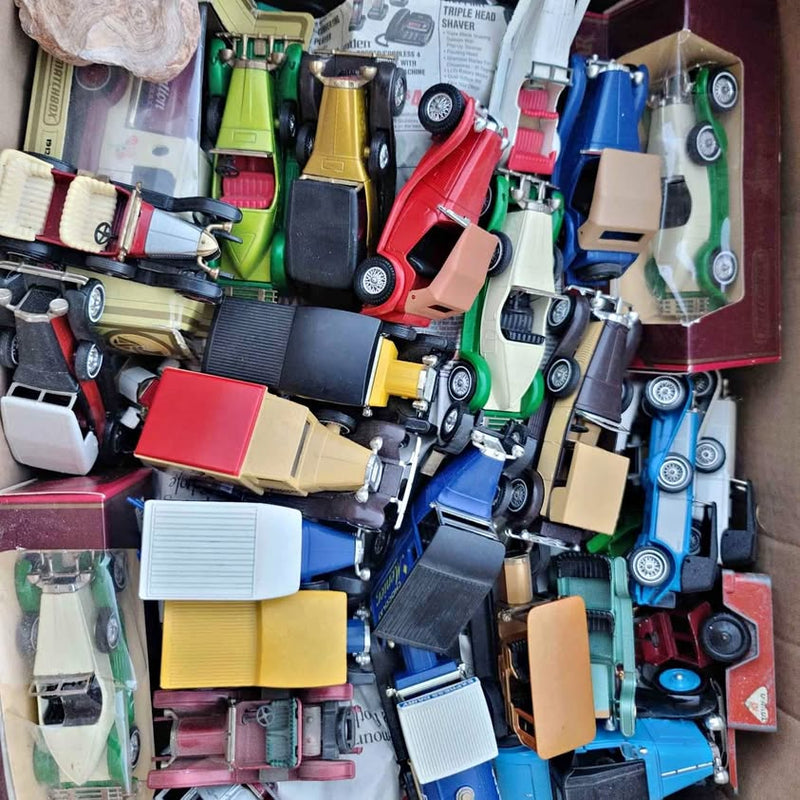 Assorted diecast car and bus models, multicolor vehicles in a mixed collection