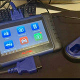 Autel IM508S diagnostic tablet with blue touchscreen and side ports, with blue cable.