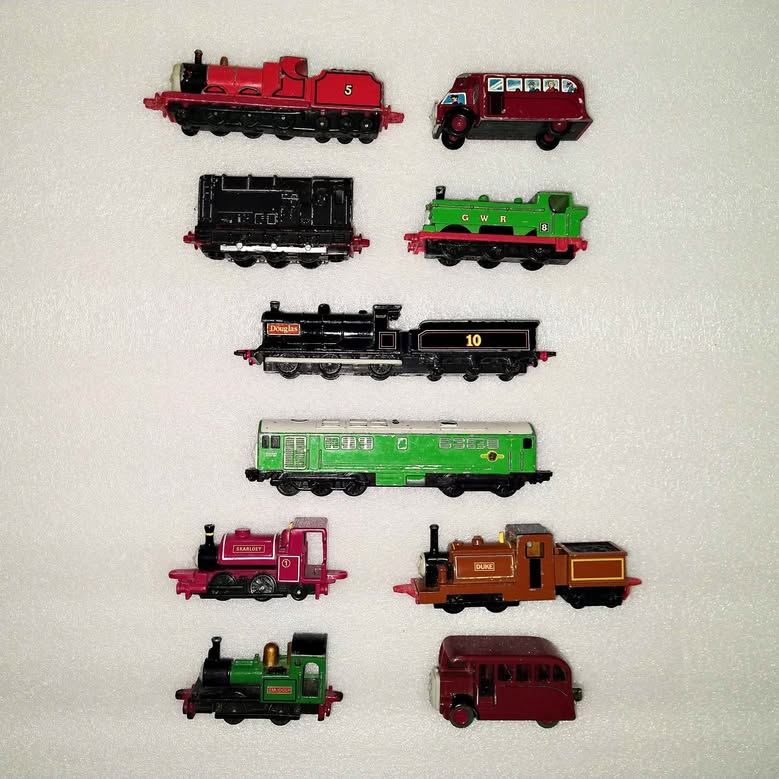 Vintage diecast Thomas train bundle with multiple colorful engines and cars