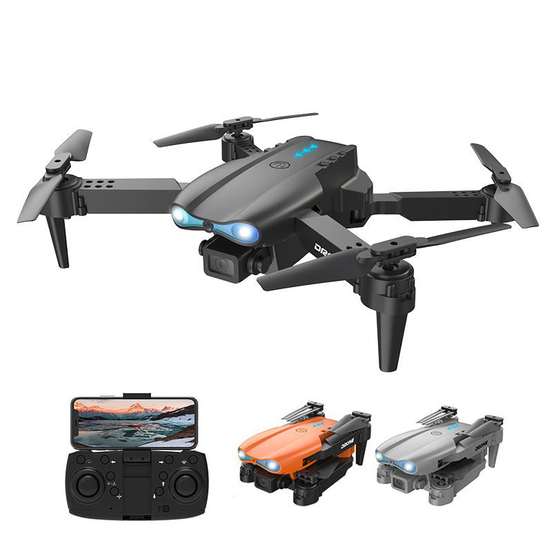 Gray mini quadcopter drone with camera, four propellers, blue LEDs, remote controller