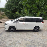 White MPV diecast model car, side profile with sliding door and black wheels