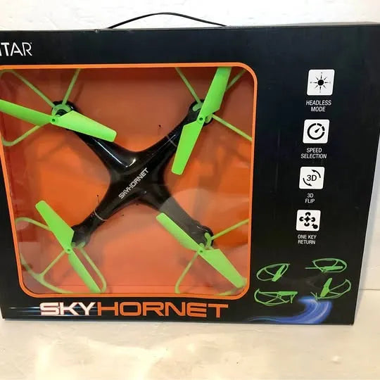 Quadcopter drone in retail box with clear window and green four-blade propellers