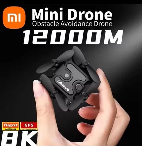 Compact mini quadcopter drone with camera, folded arms, held in hands
