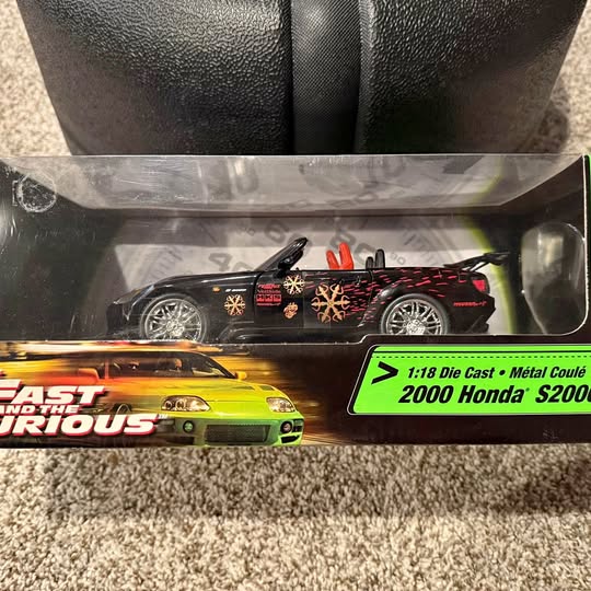 1:18 black diecast racing coupe with red decals; small view of yellow car