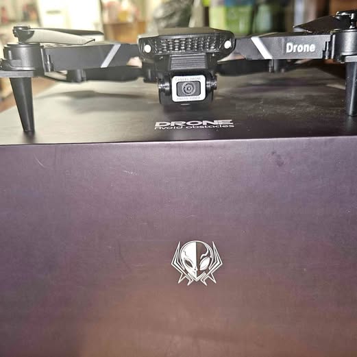Drone with front camera module and four propeller arms