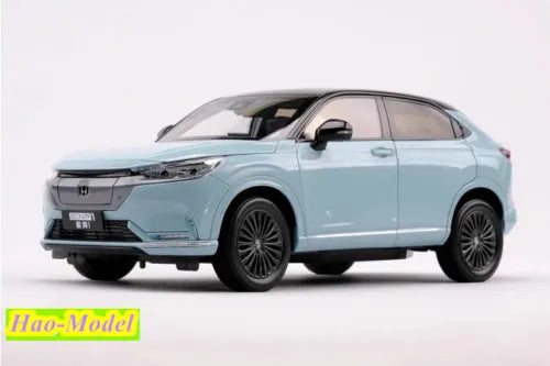 Light blue diecast car model with front grille and headlights, Honda e:NP1, 1:18 scale