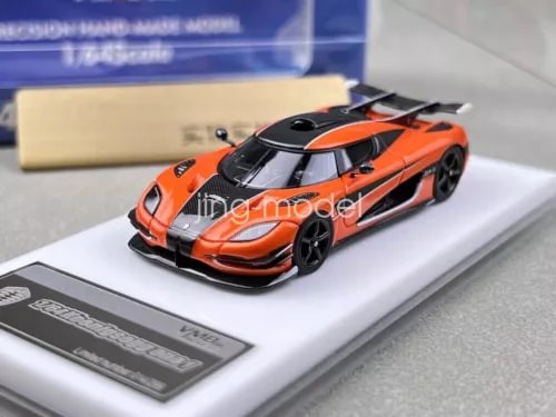 Orange racing model diecast car with black wheels on display base