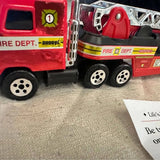 Red diecast firetruck toy with silver ladder and detailed wheels