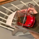 Red Tesla Model 3 diecast car in clear display case, 1/43 scale