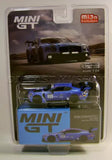 Blue and green race car diecast model in blister packaging, front view