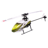 RC helicopter with green-and-white fuselage, black frame, skids and tail rotor