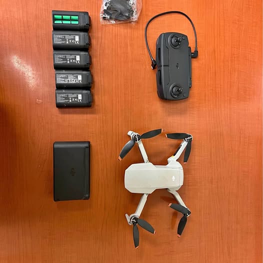 DJI Mavic Mini drone kit with controller, battery, and spare parts