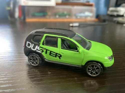 1:64 diecast model car in lime green and black with open windows and DUSTER graphics
