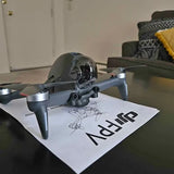 DJI folding drone with four propellers, grey body, front camera mount