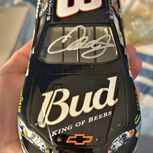 Autographed diecast race car with signature on black hood