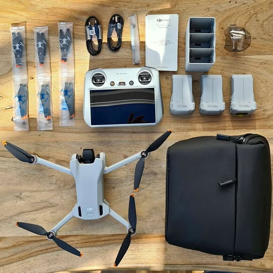 Foldable 4K drone with propellers, charging hub, extra batteries, cables, and hard case