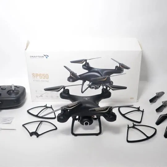 Black quadcopter drone with remote controller and accessories