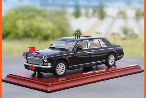Black HongQi limousine diecast model car on red display base, front 3/4 view