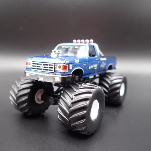 Blue monster truck diecast model with oversized front and rear tread wheels