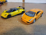 Diecast sports cars, yellow and orange, 1:36 scale, front and side views