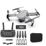 Gray quadcopter drone kit with camera, remote controller, spare propellers and carry case