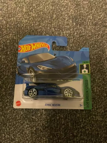 Hot Wheels diecast car in blister pack, dark blue sports car