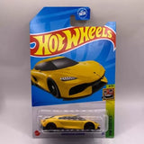 Yellow die-cast toy sports car in blister pack, Hot Wheels Koenigsegg