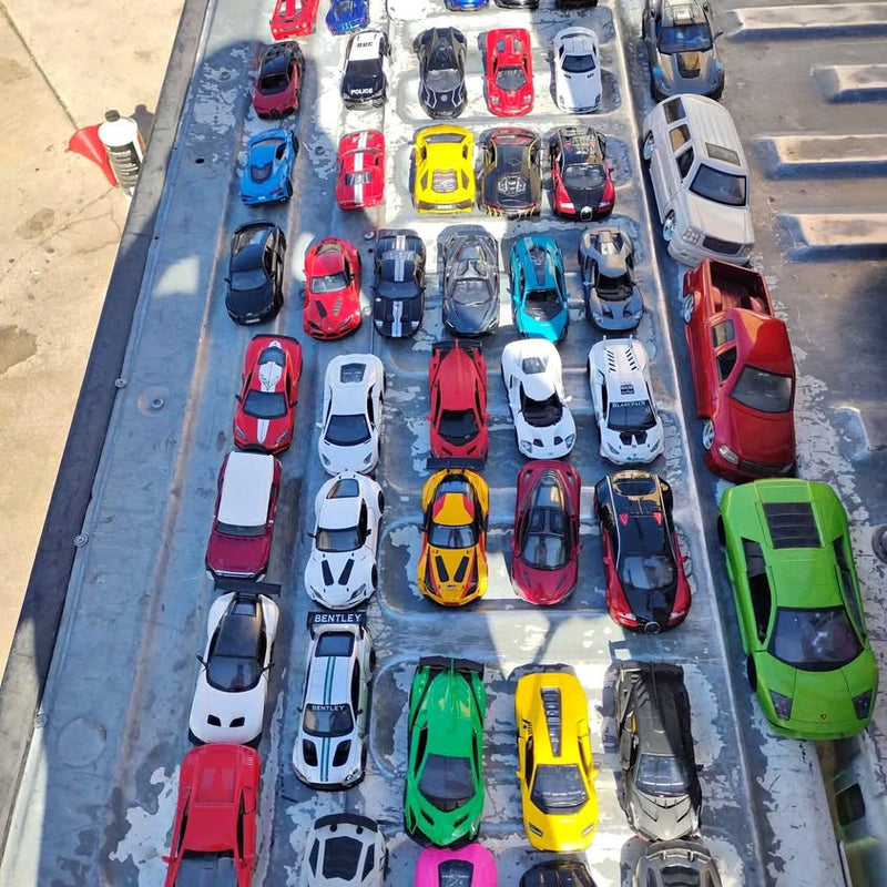Diecast supercar collectible cars, assorted colors and models, neatly arranged for display.