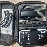 Black drone with propellers and controller in open hard-shell case