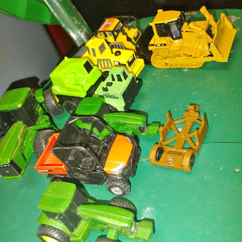 Diecast tractor set with green, yellow, and orange toy tractors, loader attachments, wheels