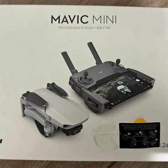 Folding quadcopter drone with gray arms and remote controller