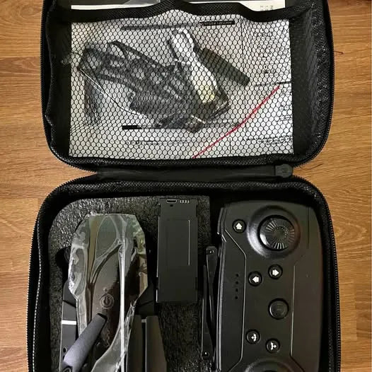 Drone and controller in zippered hard case with mesh divider, accessories inside