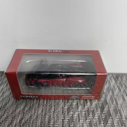 Red diecast model car in display box with clear window