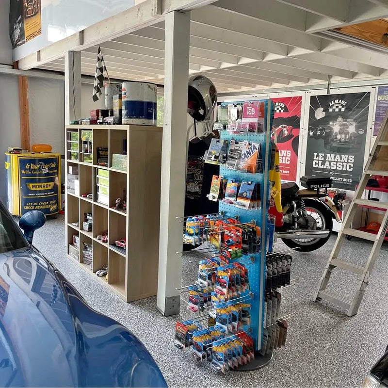 Diecast car display shelves with boxed models and banners, plus blue car hood