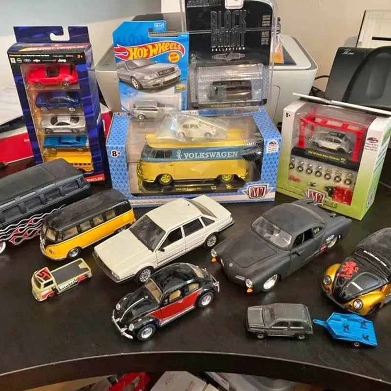 Diecast toy car lot with assorted vehicles in yellow, white, gray, and red