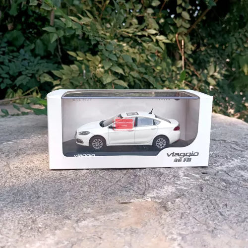 White diecast model car in a clear display box with branding on base