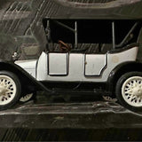 Vintage diecast metal car model with white body, grille, and front wheels