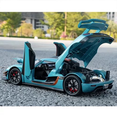 Koenigsegg One:1 1:24 diecast sports car toy, teal blue with open doors and exposed engine.