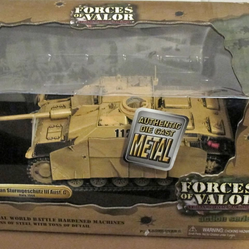 Diecast tank model in clear retail box, tan armored vehicle front