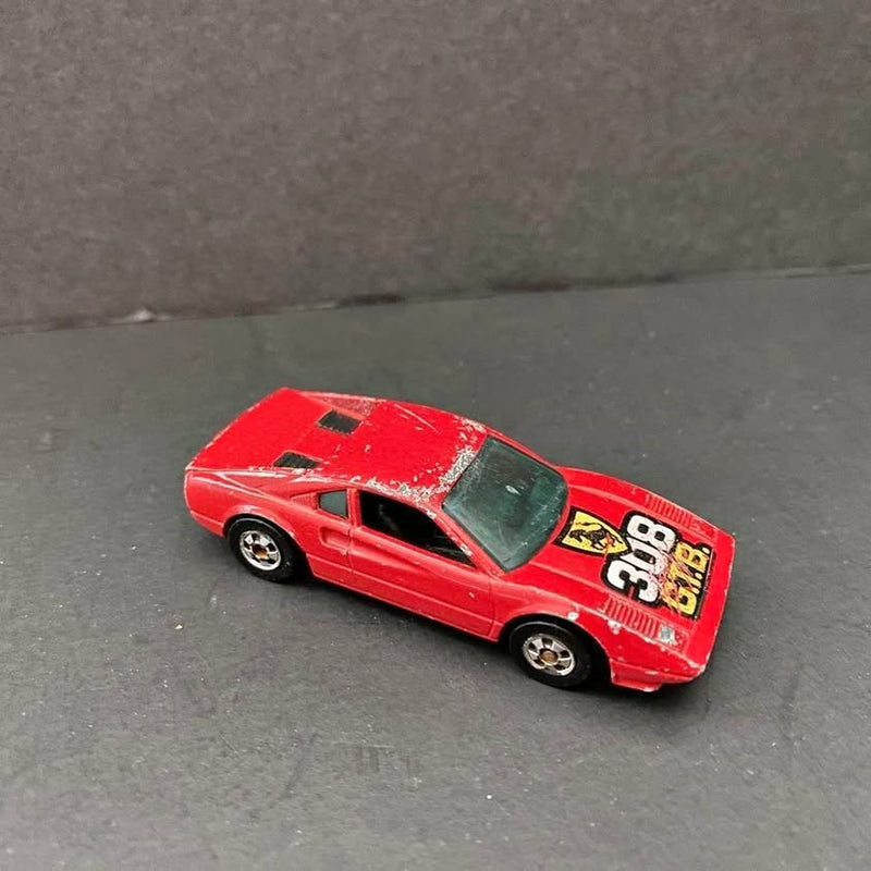 Red diecast sports car with black windows and white 98 on side